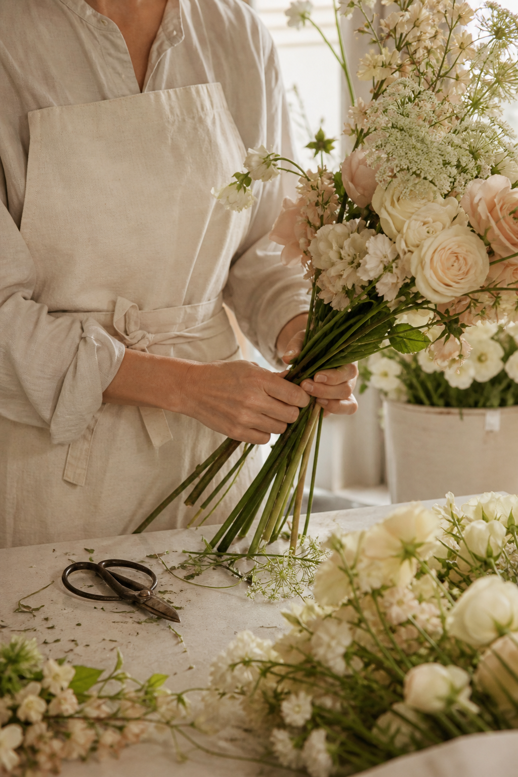 Florist composing a seasonal bouquet by hand
